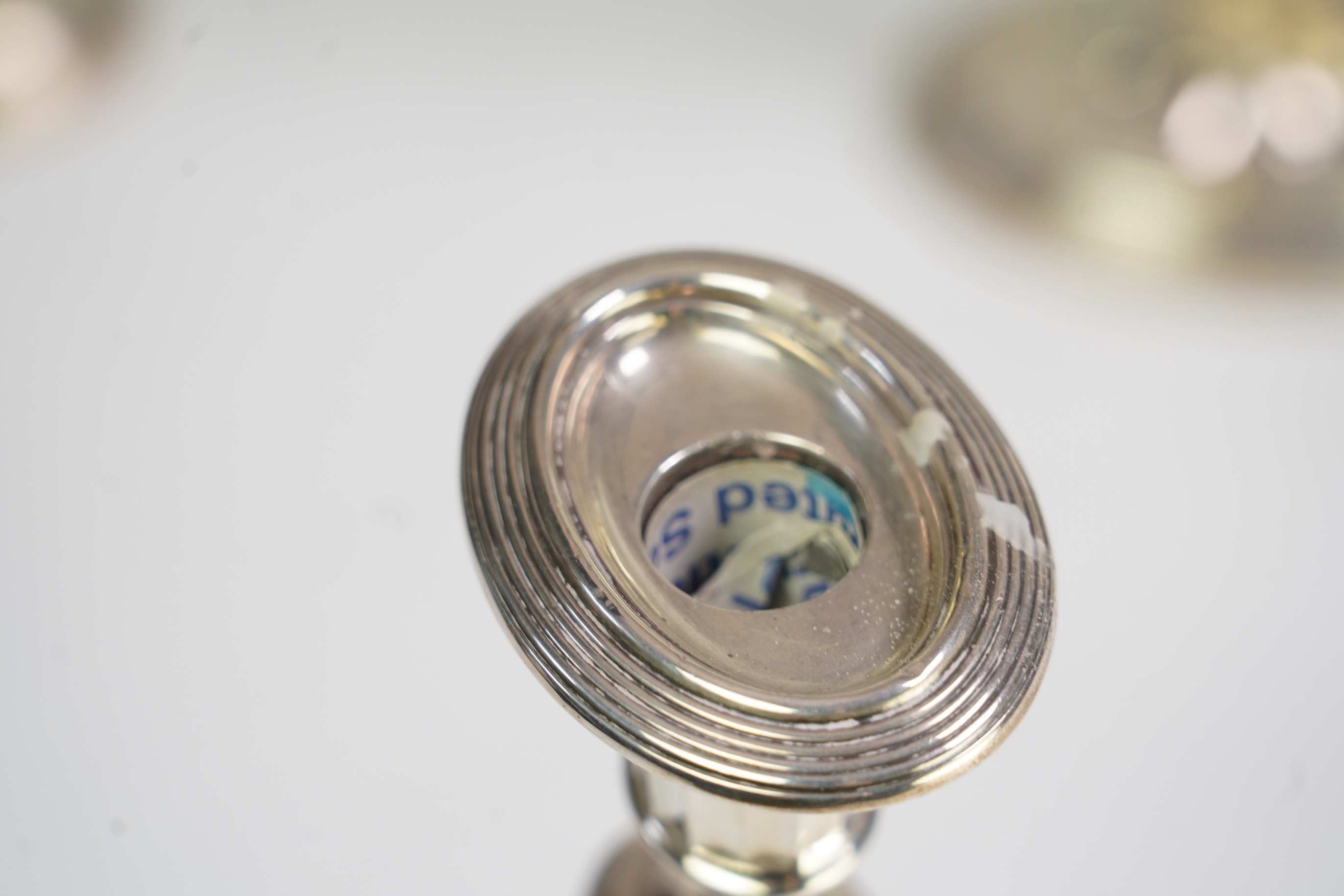 A matched set of four Edwardian fluted silver candlesticks, by Sibray, Hall & Co Ltd